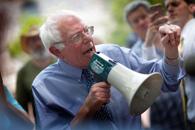 CONCORD, NH - MAY 27: Democratic presidential candidate and U.S. Sen. Bernie Sanders (I-VT) speaks to an overflow crowd through a megaphone after a campaign event at the New England College May 27, 2015 in Concord, New Hampshire. Sanders officially declared his candidacy yesterday and will run as a Democrat in the presidential election and is former Secretary of State Hillary ClintonÃ?s first challenger for the Democratic nomination. (Photo by Win McNamee/Getty Images)